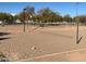 Outdoor sand volleyball court with net in place and surrounding trees at a community park at 255 S Kyrene Rd # 115, Chandler, AZ 85226