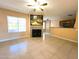 Open-concept living room featuring fireplace, and seamless access to the kitchen and dining areas at 255 S Kyrene Rd # 115, Chandler, AZ 85226