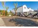 View of the community entrance, enhanced by mature trees, landscaping, and a modern, gated entrance at 2604 N 27Th St # 4, Phoenix, AZ 85008