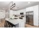 Modern kitchen featuring white cabinets, stainless steel appliances, and a quartz-topped island with bar seating at 2604 N 27Th St # 4, Phoenix, AZ 85008