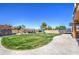 Spacious backyard with green lawn, covered seating area, playground, and manicured landscaping providing privacy at 3016 N Glenview --, Mesa, AZ 85213