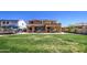 View of the home's backyard featuring a large lawn, covered patio, and lush landscaping, perfect for outdoor entertaining at 3016 N Glenview --, Mesa, AZ 85213