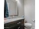 Half bathroom featuring dark wood vanity with marble countertop, toilet and towel at 3016 N Glenview --, Mesa, AZ 85213