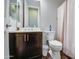 Bathroom showcasing a vanity with dark wood cabinetry and a toilet with wood-look flooring at 3016 N Glenview --, Mesa, AZ 85213