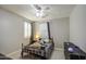 Cozy bedroom featuring a ceiling fan, plantation shutters and dark wood dresser at 3016 N Glenview --, Mesa, AZ 85213