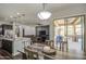 Inviting dining area featuring a modern light fixture and seamless access to the covered outdoor patio at 3016 N Glenview --, Mesa, AZ 85213