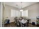 Dining room with a dark wood table, chairs, modern lighting fixture, and plantation shutters at 3016 N Glenview --, Mesa, AZ 85213