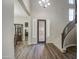 Spacious foyer with hardwood floors, staircase, decorative front door, and views of the dining room at 3016 N Glenview --, Mesa, AZ 85213