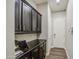 Hallway featuring dark wood cabinets and a countertop, with a view of the door at 3016 N Glenview --, Mesa, AZ 85213