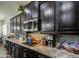 Granite counters and dark cabinets provide a modern and stylish feel to this well-equipped kitchen space at 3016 N Glenview --, Mesa, AZ 85213