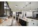 Open-concept kitchen with a large island, dark wood cabinets, and modern stainless steel appliances at 3016 N Glenview --, Mesa, AZ 85213