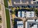 Aerial view of modern apartment buildings with parking lots, landscaping, and nearby canal at 3434 E Baseline Rd # 213, Phoenix, AZ 85042