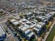 Aerial view of the apartment complex with lush landscaping, parking, and a community pool at 3434 E Baseline Rd # 213, Phoenix, AZ 85042