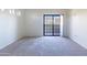 A bright and spacious bedroom with a glass sliding door to a balcony at 3434 E Baseline Rd # 213, Phoenix, AZ 85042