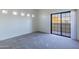 A bedroom that features carpeted floors and a glass sliding door leading to the outside at 3434 E Baseline Rd # 213, Phoenix, AZ 85042