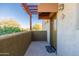 View of the front porch with stucco walls and a decorative pergola, offering a cozy outdoor space at 3434 E Baseline Rd # 213, Phoenix, AZ 85042