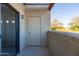 Private patio space with sliding glass door and enclosed off white walls at 3434 E Baseline Rd # 213, Phoenix, AZ 85042
