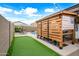 A delightful backyard featuring a putting green, patio with grilling area, and relaxing lounge chairs by the pool at 37340 W Merced St, Maricopa, AZ 85138