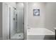 Bright bathroom showcasing a tub with a shower head and a separate standing shower at 37340 W Merced St, Maricopa, AZ 85138