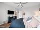 A cozy bedroom with a ceiling fan, a TV, and a comfortable bed at 37340 W Merced St, Maricopa, AZ 85138