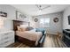 Comfortable bedroom with a ceiling fan, a queen-sized bed, nightstand, and an abundance of natural light at 37340 W Merced St, Maricopa, AZ 85138