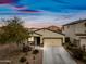 Charming single-story home featuring a well-maintained desert landscaped yard, with a two car garage at 37340 W Merced St, Maricopa, AZ 85138