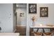Hallway featuring modern decor on a console table with decorative accents and wall art at 37340 W Merced St, Maricopa, AZ 85138
