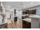 Well-lit kitchen showcases dark cabinets, stainless steel appliances, and an open layout at 37340 W Merced St, Maricopa, AZ 85138
