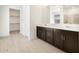 Bathroom showcasing dual sinks, dark wood cabinets and quartz countertop at 4029 S 176Th Dr, Goodyear, AZ 85338