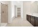 Bathroom featuring a tiled shower, dual vanity and linen closet at 4029 S 176Th Dr, Goodyear, AZ 85338