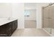 Bathroom highlighting a dark wood vanity with white countertop and tiled shower at 4029 S 176Th Dr, Goodyear, AZ 85338