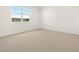 Bedroom with plush carpet and a large window at 4029 S 176Th Dr, Goodyear, AZ 85338
