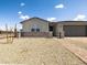 Single story house with a gray tiled roof, desert landscaping, and a gray two car garage at 4029 S 176Th Dr, Goodyear, AZ 85338