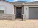 The front door features stone columns and a brick walkway with low decorative fencing at 4029 S 176Th Dr, Goodyear, AZ 85338