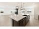 Open-concept kitchen featuring a large island, stainless steel appliances, and pendant lighting at 4029 S 176Th Dr, Goodyear, AZ 85338