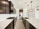 Gourmet kitchen featuring stainless steel appliances, gas range, and dark wood cabinetry at 4029 S 176Th Dr, Goodyear, AZ 85338