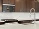 Close-up of kitchen featuring stainless steel faucet, subway tile backsplash, and gas range at 4029 S 176Th Dr, Goodyear, AZ 85338