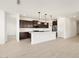Modern kitchen featuring stainless steel appliances, an island and dark wood cabinetry at 4029 S 176Th Dr, Goodyear, AZ 85338