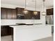Modern kitchen with white quartz countertops, dark wood cabinets and stainless steel appliances at 4029 S 176Th Dr, Goodyear, AZ 85338
