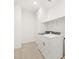 Bright laundry room equipped with a side-by-side washer and dryer, plus convenient overhead shelving at 4029 S 176Th Dr, Goodyear, AZ 85338
