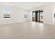Bright living space with wood-look flooring, natural light, and sliding glass doors to the backyard at 4029 S 176Th Dr, Goodyear, AZ 85338