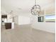 Open-concept living space with modern light fixtures, wood-look flooring, and ample natural light at 4029 S 176Th Dr, Goodyear, AZ 85338