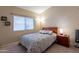 Comfortable bedroom with a large window, carpet, and neutral color palette at 4628 E Gelding Dr, Phoenix, AZ 85032