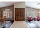 Inviting foyer showcasing a double-door entry, tile and wood flooring, complemented by decorative windows at 4628 E Gelding Dr, Phoenix, AZ 85032