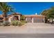 Charming single-story home featuring a three-car garage, a well-manicured lawn, and a desert landscape at 4628 E Gelding Dr, Phoenix, AZ 85032