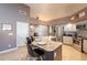 Bright kitchen with granite countertops, stainless steel appliances, and a functional island with bar seating at 4628 E Gelding Dr, Phoenix, AZ 85032