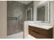 Modern bathroom featuring a glass walk-in shower and illuminated vanity mirror at 5000 N Camelback Ridge Dr # 203, Scottsdale, AZ 85251