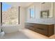 Modern bathroom with a soaking tub, dual sinks, and a desert view at 5000 N Camelback Ridge Dr # 203, Scottsdale, AZ 85251