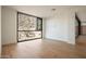 Minimalist bedroom with desert views and wooden floors at 5000 N Camelback Ridge Dr # 203, Scottsdale, AZ 85251