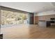Spacious living room with modern kitchen, wooden floors, and large balcony sliding glass doors at 5000 N Camelback Ridge Dr # 203, Scottsdale, AZ 85251